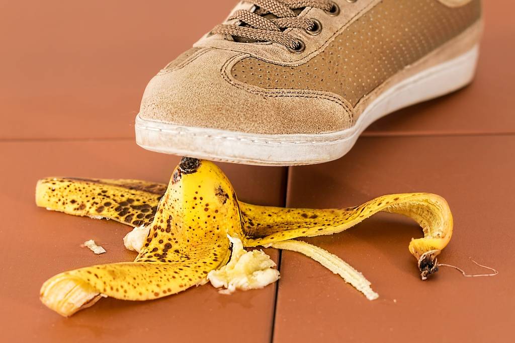 Person stepping on a banana - accidents do happen so get travel insurance!