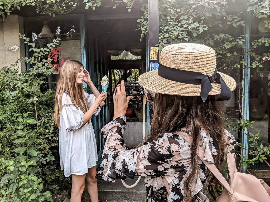 Lina taking a picture of Laura with Ice Cream in Pinjing Street