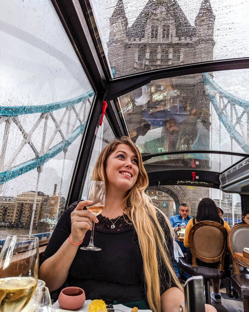 Sarah sipping Champagne during the afternoon tea with a view with Bustronome London