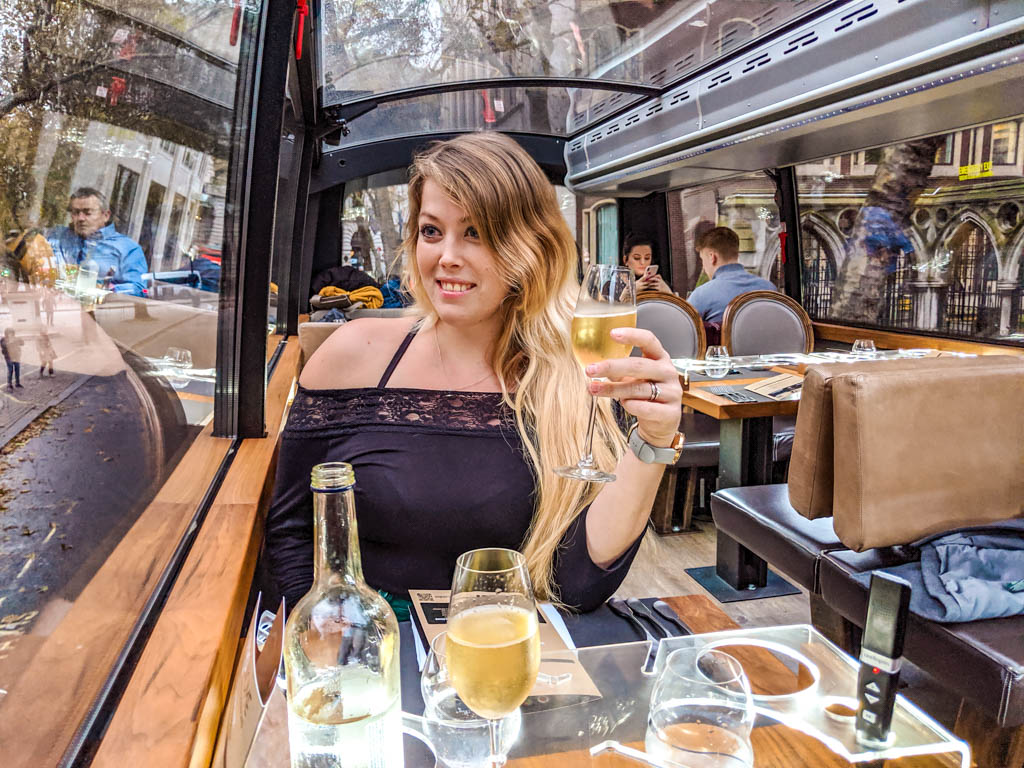 Sarah sipping Champagne onboard of Bustronome London Afternoon Tea Bus Tour