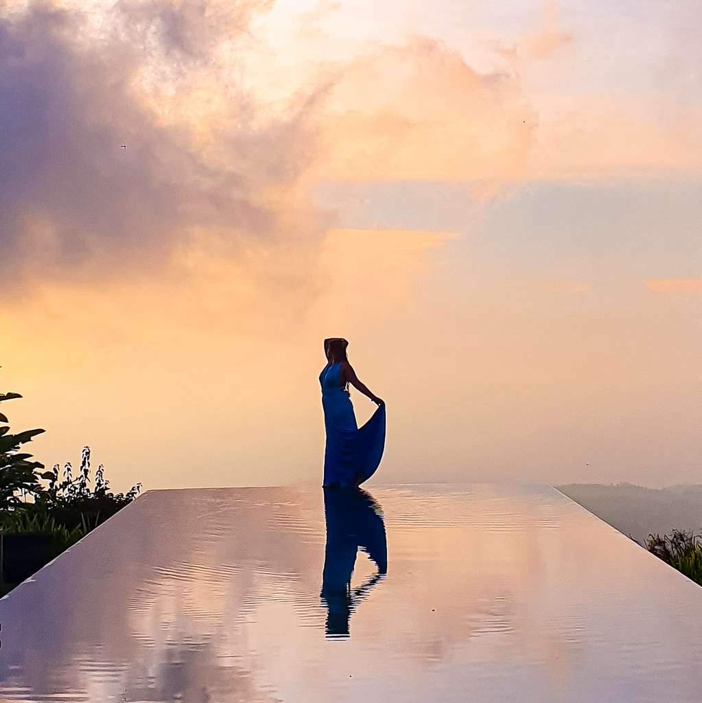 Sarah in an evening dress during sunset at Munduk Moding Plantation Infinity Pool