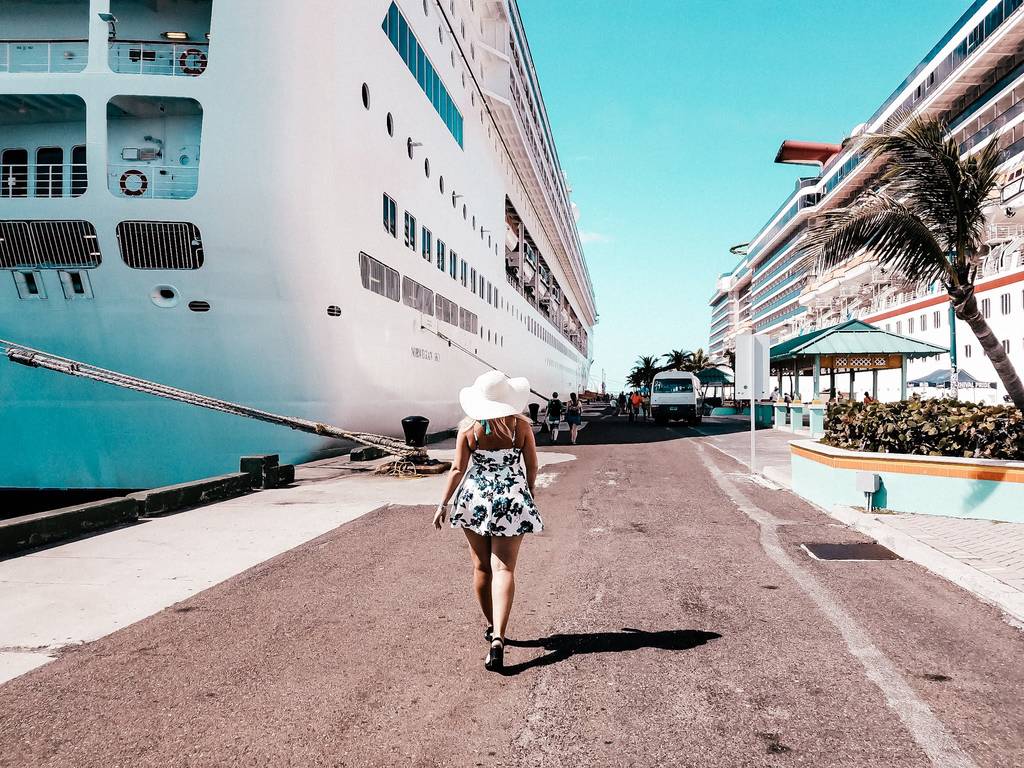 Sarah wearing a casual dress in port while walking towards a cruise ship from Norwegian NCL