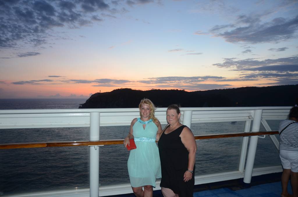 Sarah wearing a turquoise dress considered "cruise elegant" dress code